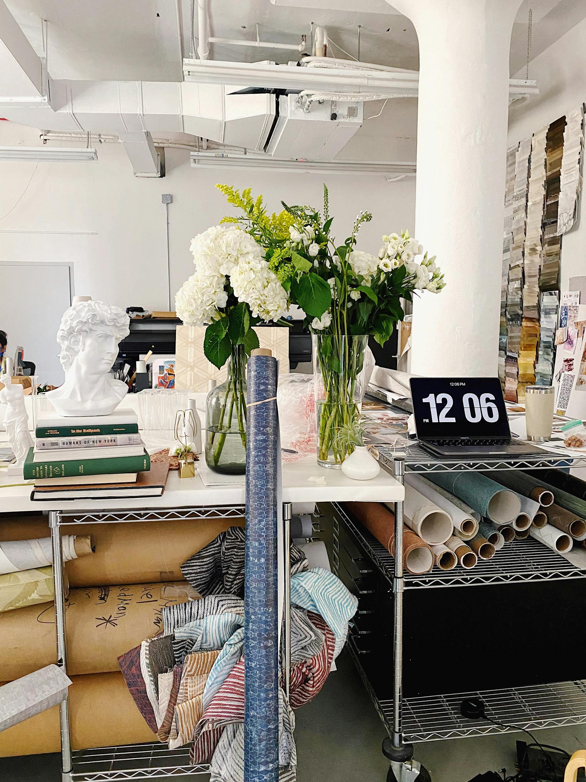 A vibrant art studio in New York City featuring floral arrangements and art supplies.